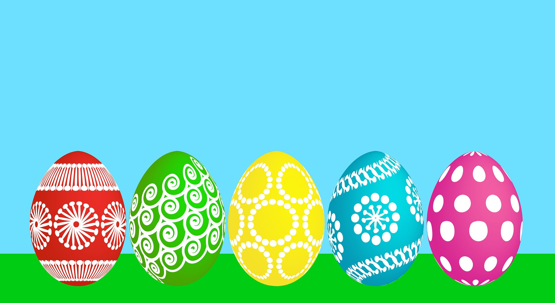 Place card with five decorated Easter eggs on grass under a blue sky